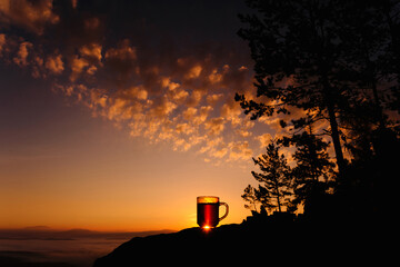 A hot cup of tea at dawn in the mountains.