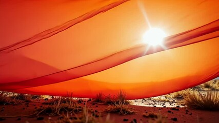 Sunlight Filtering Through Red Fabric in a Desert Landscape   - Powered by Adobe
