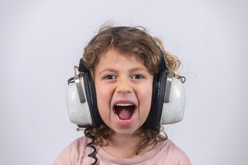 child making faces wearing vintage headphones
