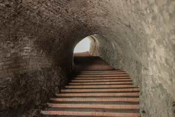 Stairs ladder leading to the Petrovaradin Fortress, Novi Sad, Serbia. Stone steps and archway. tunnel arches with stairway up perspective.
