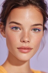 Fototapeta premium model with bold colorful eyeliner and glossy lips posing against pastel background
