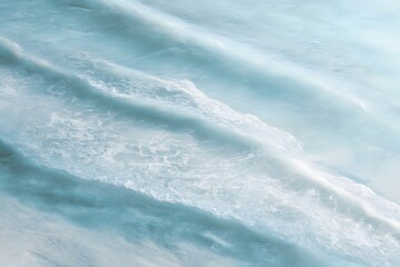 Serene Ocean Waves Glistening in Soft Natural Light over Blue Water