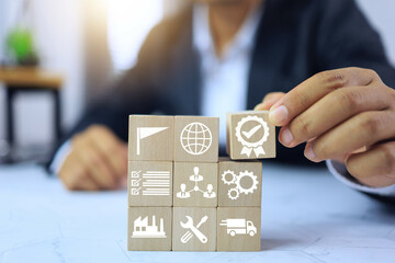 certification concept with businessman arrange wooden block for factory quality system management...