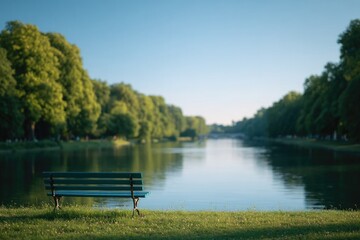 empty park bench facing serene pond in green park casting long shadows in early morning light