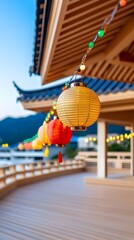 Fototapeta premium Colorful paper lanterns illuminate a wooden deck overlooking a serene mountain vista at dusk