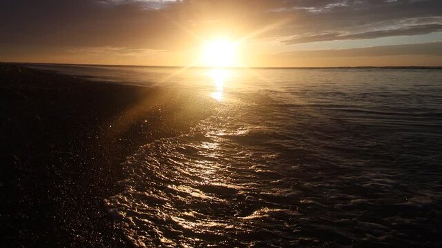 Sunset along wild coast of Sea of Japan. Sakhalin. A beach, ocean meadow, and lots of caddis fly. Far East, here begins night and day of extended Siberia. Sea is like maternity hospital for cyclones