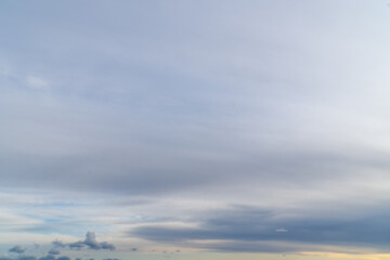 Stormy sky with dark, snowy clouds on a spring day. Clouds are floating across the sky. Dramatic clouds. Dark blue clouds swiftly floating across blue sky. Sky texture, abstract nature background.