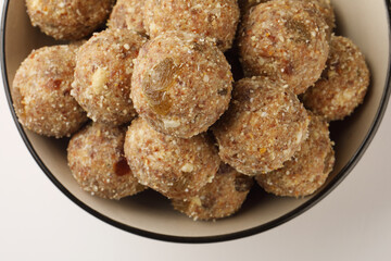 Healthy snacks, fitness lifestyle and high fiber diet concept with dates and dryfruits energy Laddus or Ladoo surrounded by dried fruits, Cashew Nuts, pistachios , almonds