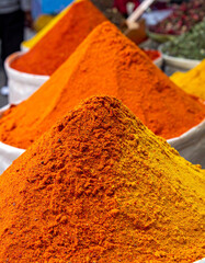 Brightly colored spices in a Saudi Arabian souq (market) offer aromatic vibrancy.
