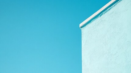 Obraz premium Minimalist Building Facade with Turquoise Stucco Against a Clear Blue Sky