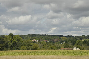 Contraste entre le gris des nuages et le vert de la colline boisée près du bourg de Champagne au Périgord Vert 