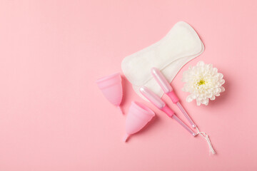 Menstrual cup on a bright background. Sanitary napkins, tampons and menstrual cup.Concept of critical days, menstruation.feminine hygiene product. Women health concept.Premenstrual syndrome.Copy space