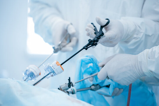 Close-up of surgeons performing laparoscopic surgery with precision instruments for extraction of kidney stones