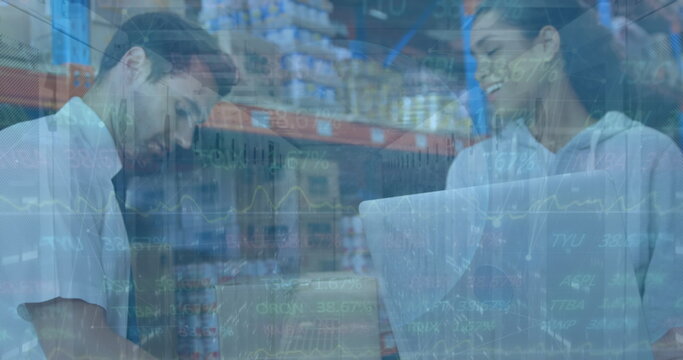 Image of financial graphs over happy diverse female and male warehouse workers