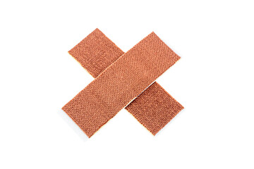 Medical adhesive bandage isolated on white background. Crossed bandage.