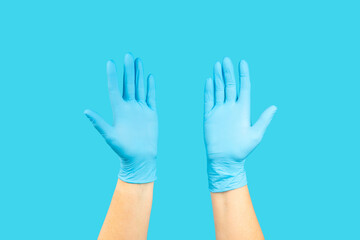 Medical nitrile gloves,blue cap, disposable medical mask on textured background. Medic protective clothing. Surgical latex gloves. Rubber gloves manufacturing.Medicine concept. Top view. Copy text