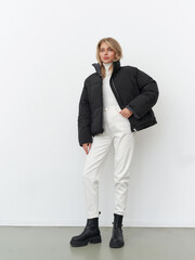 Stunning female model showcasing contemporary fashion in a minimalist studio setting