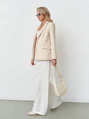 Stylish model poses gracefully in a chic studio setting with elegant fashion attire