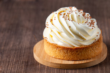 Lemon tartlets with whipped cream, sprinkles and chocolate chips on white background