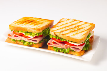 Club sandwich with ham, cheese, tomato and lettuce