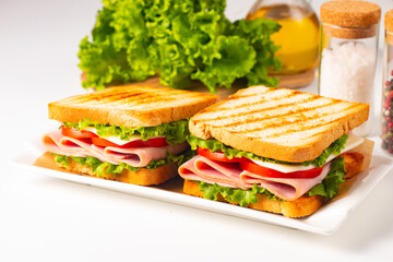Club sandwich with ham, cheese, tomato and lettuce