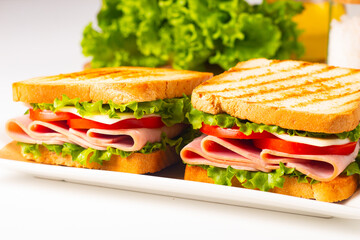 Club sandwich with ham, cheese, tomato and lettuce