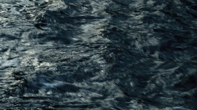 The rapid flow of water in a forest river. The inflow of fresh water. Close-up of a water stream. Natural background image.