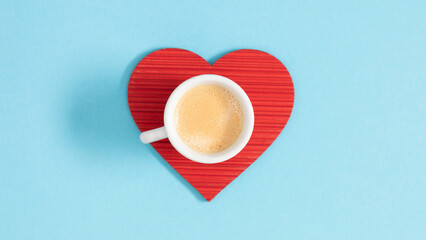 Top view. Cup of aromatic hot coffee and red heart coaster on pale blue background.