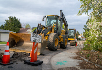 sidewalk closed - sign and barrier on a residential street for construction with heavy machinery © MarekPhotoDesign.com