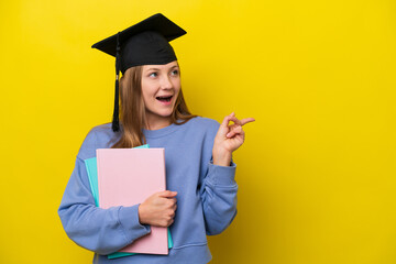 Young student Russian woman isolated on yellow background intending to realizes the solution while...