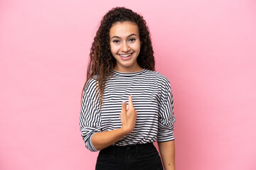 Young hispanic woman isolated on pink background with surprise facial expression