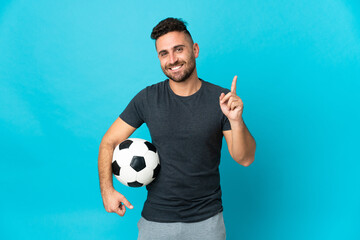 Football player isolated on blue background showing and lifting a finger in sign of the best
