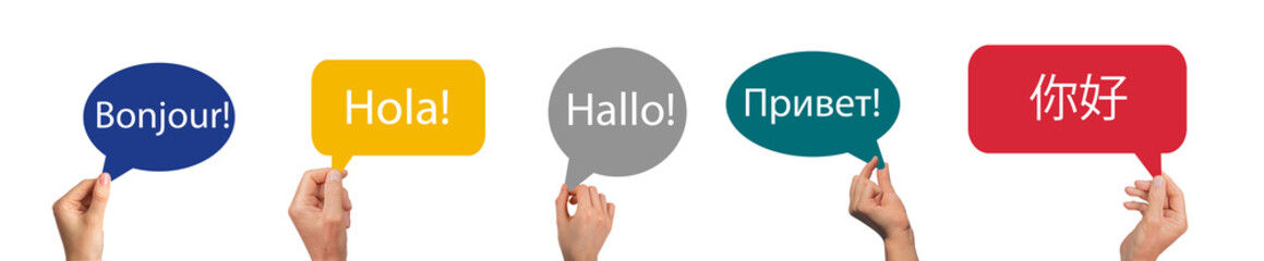 Speech bubbles in hands with word hello in foreign languages. French, Spanish, German, Russian and © valiantsin