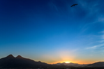 Sunset at La Isleta del Moro with Los Frailes volcanoes seen at left