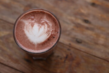 Hot latte coffee on wood background
