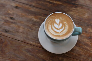Hot latte coffee on wood background