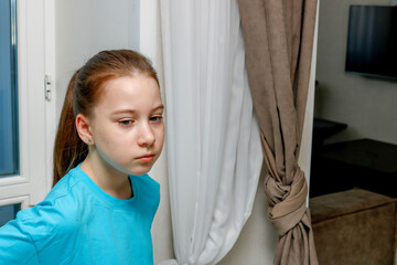 portrait of a cute teenage girl at home preoccupied with her personal problems