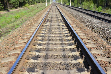 Fototapeta premium View along railroad tracks stretching into the distance