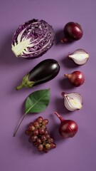 Still life of purple vegetables and grapes on dark background