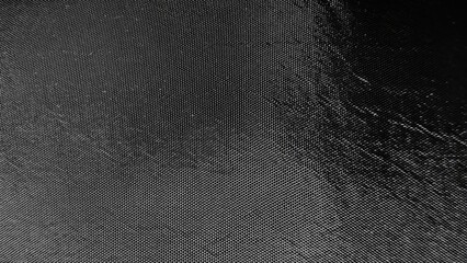 black textured nylon fabric background with reflective sheen for web design, print materials,...