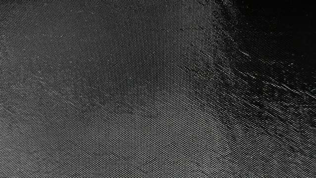 black textured nylon fabric background with reflective sheen for web design, print materials, branding mockups, or digital surface pattern resources

