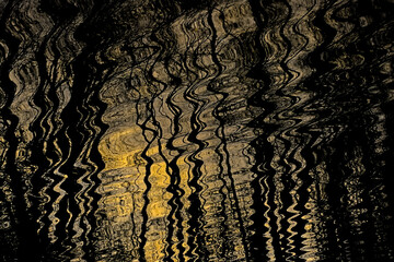 Dark wavy water with bright reflection of sunlight. abstract nature background 