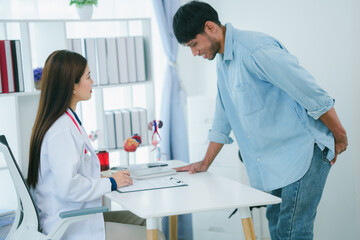 Obraz premium A man is consulting a doctor about hemorrhoids. Squeezing his buttocks. Sees a proctologist to discuss anal problems. Hemorrhoids or treatment concept