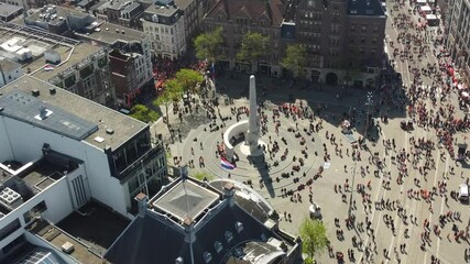 Aerial drone view of Amsterdam city center the Dam Square during King's Day Koningsdag a Dutch spring holiday and a popular tourist attraction in the Netherlands Holland 4k quality