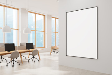 Modern office with large blank poster on white wall and city view through windows in bright interior design setting. 3D Rendering