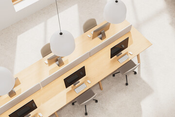 Top view of modern office interior design with shared wooden desks, minimalist chairs, and pendant lights in bright neutral workspace. 3D Rendering