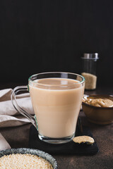 Tahini latte with sesame spread in a cup on the table vertical view