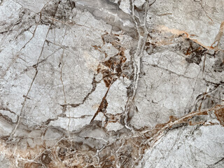 Natural bright golden grey marble texture with  dark red veins and black veins. Bright warm grey natural marble stone, Seamless background texture.
