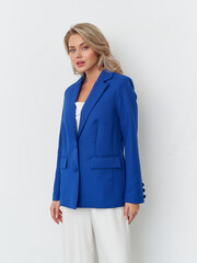 Chic fashion model showcases vibrant blue blazer in modern studio setting