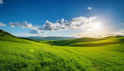 Fototapeta premium vibrant landscape with rolling hills green grass bright sun and fluffy clouds under a clear blue sky